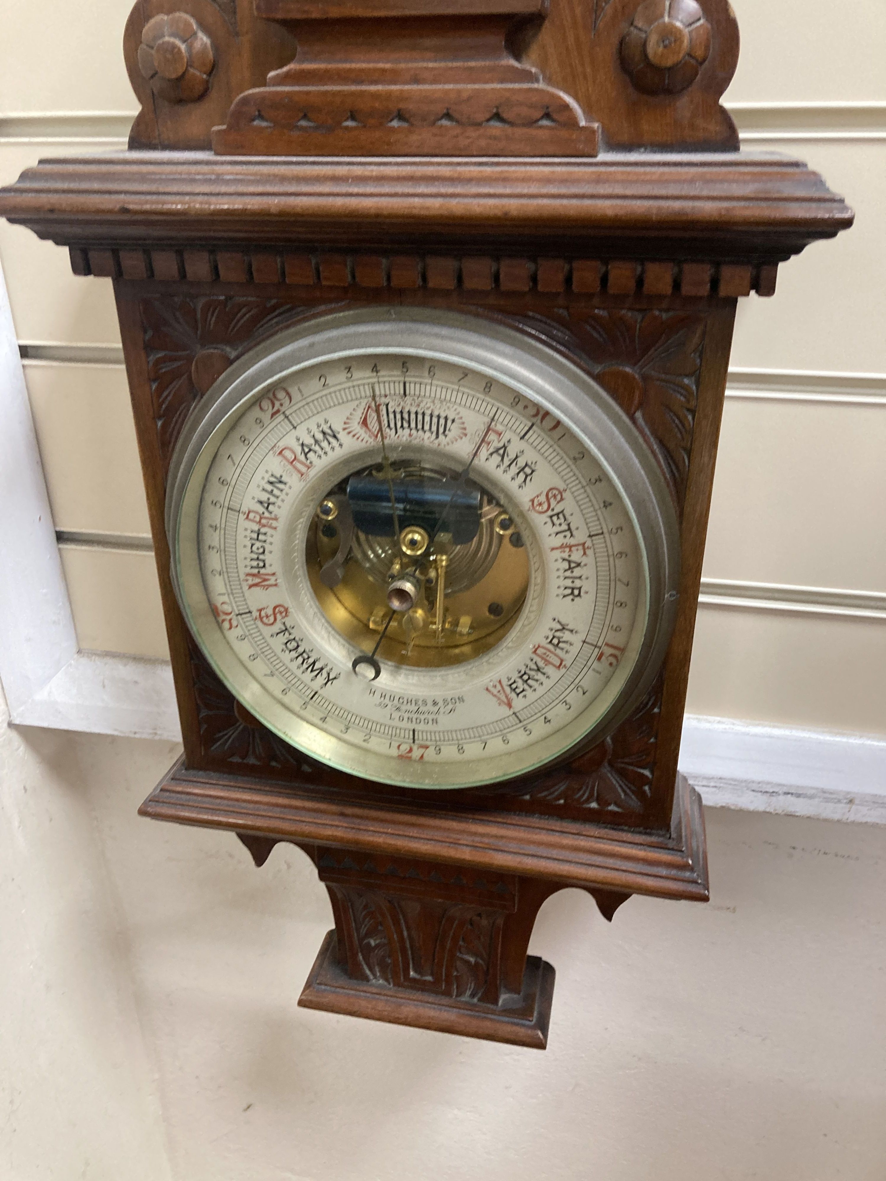 A Victorian carved mahogany wall hanging barometer, the silvered dial marked H. Hughes & Sons, 59 Fenchurch Street, London, height 92cm